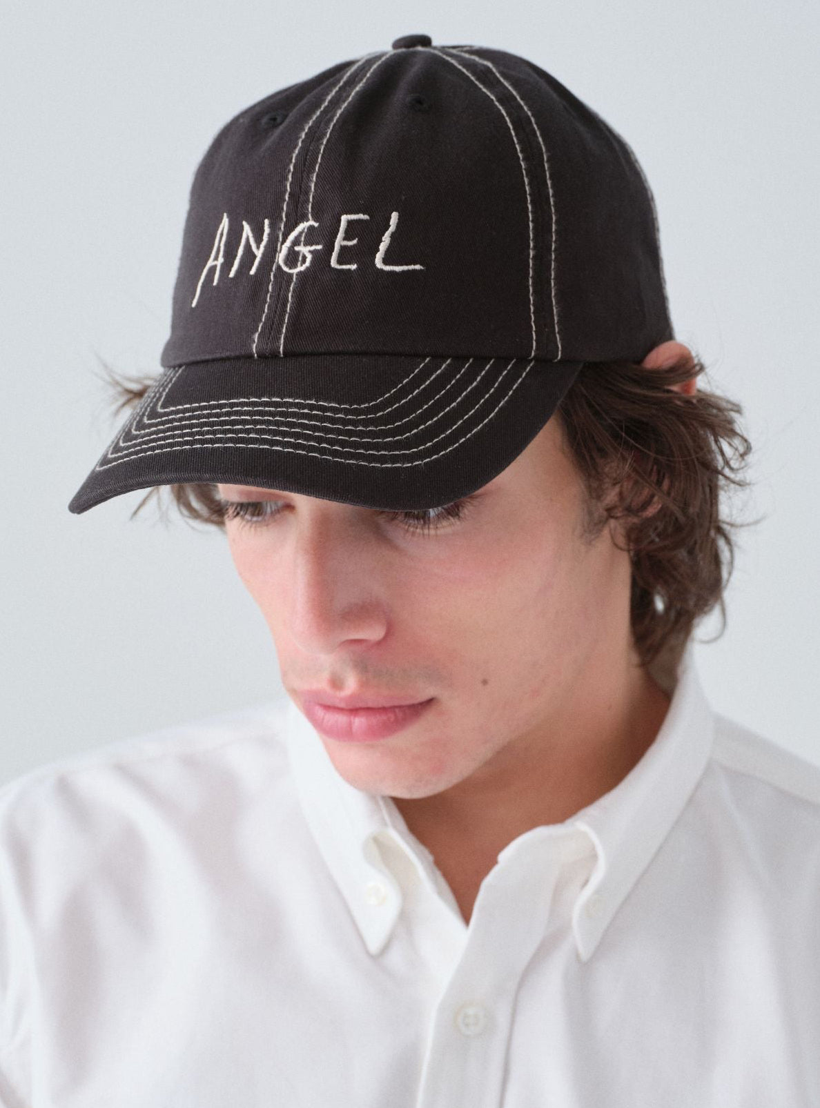 Hanover Angel contrast stitch hat on model with 'Angel' embroidery 