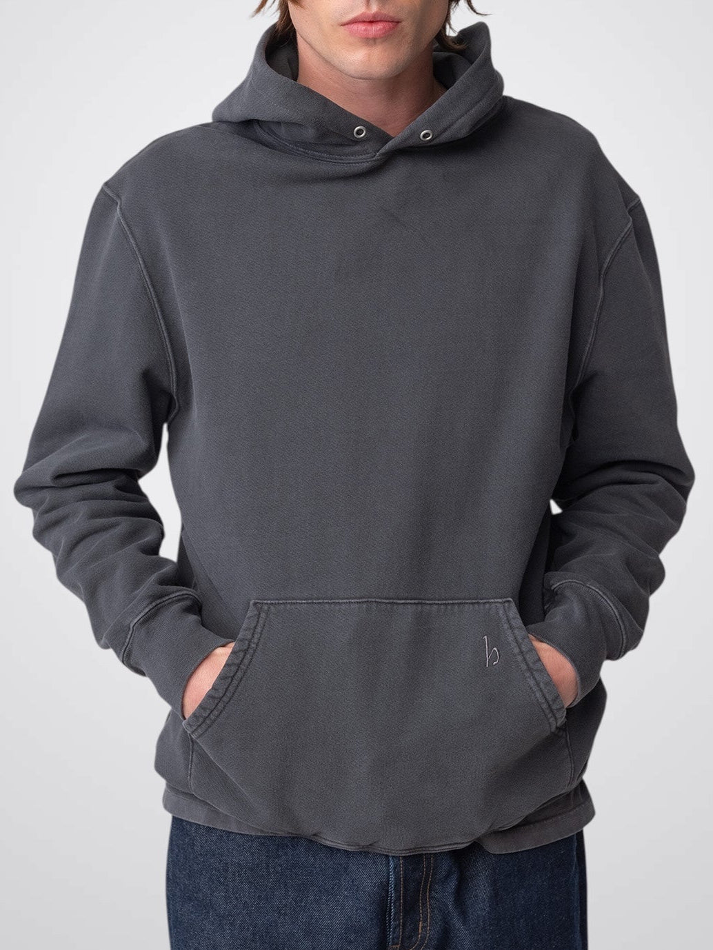 Model wearing Sunwashed Staple Hoodie in charcoal