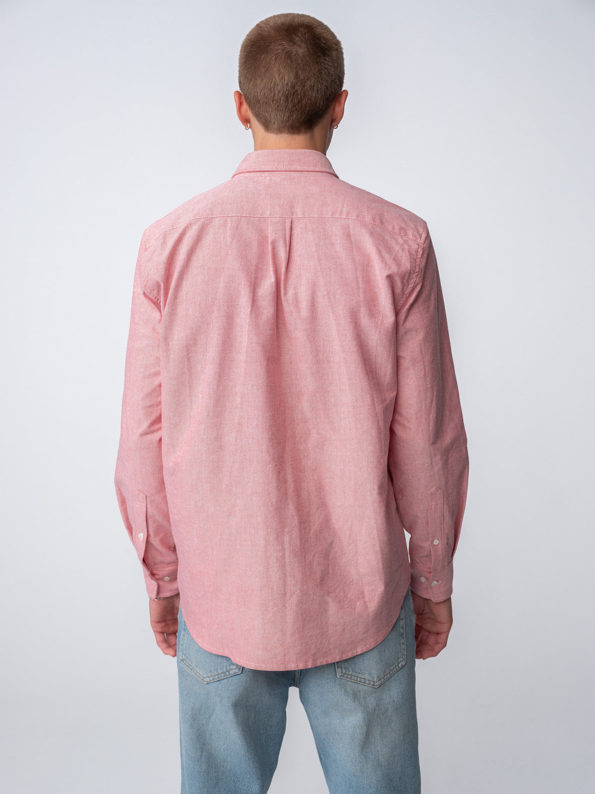 Back view of guy wearing Hanover Essential Oxford Shirt in Red on model