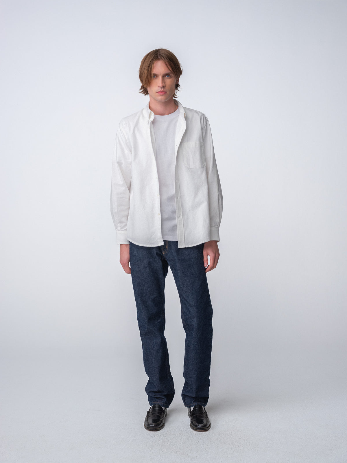Full body Side view of guy wearing Hanover Essential Oxford Shirt in White on model