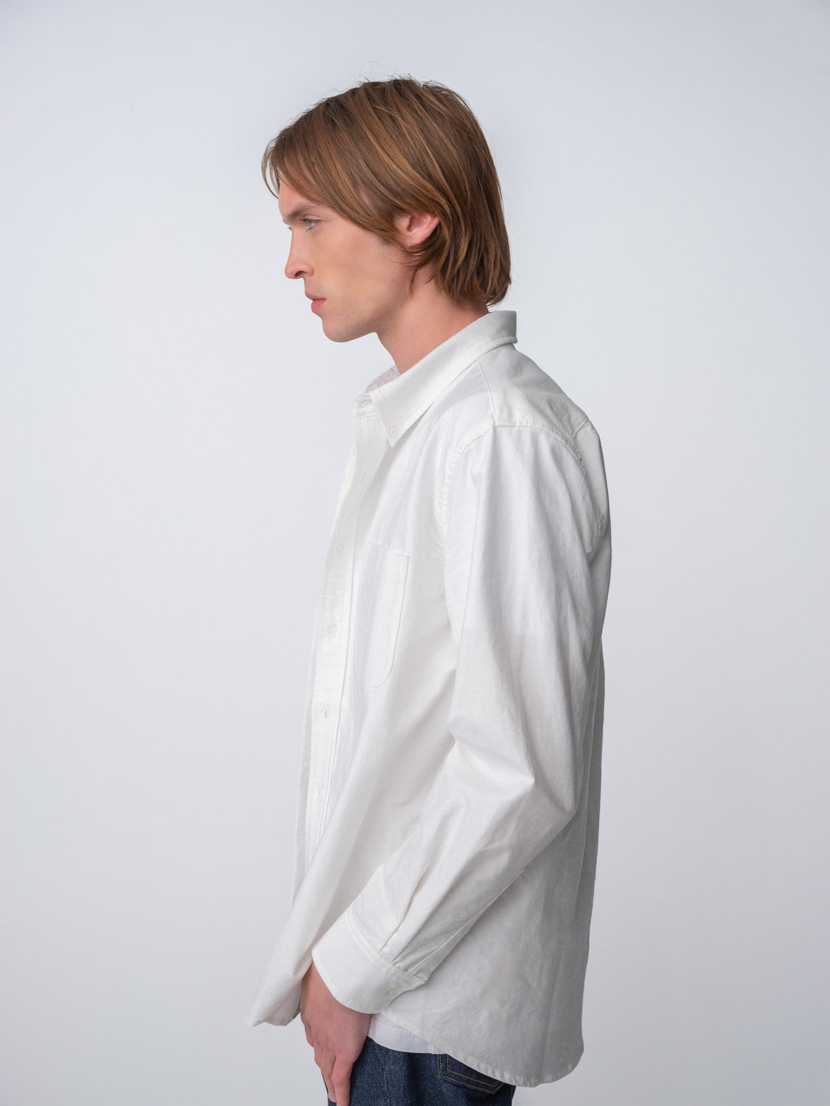 Side view of guy wearing Hanover Essential Oxford Shirt in White on model