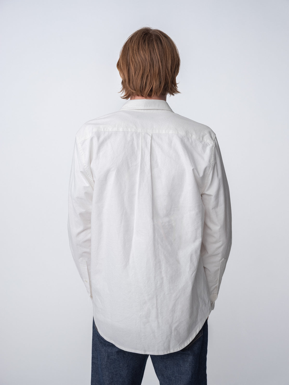 Back view of guy wearing Hanover Essential Oxford Shirt in White on model