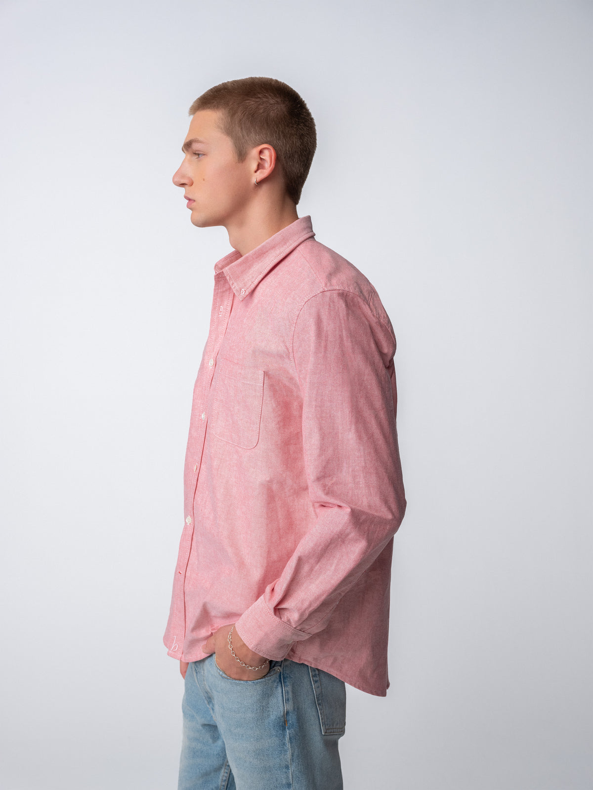 Side view of guy wearing Hanover Essential Oxford Shirt in Red on model