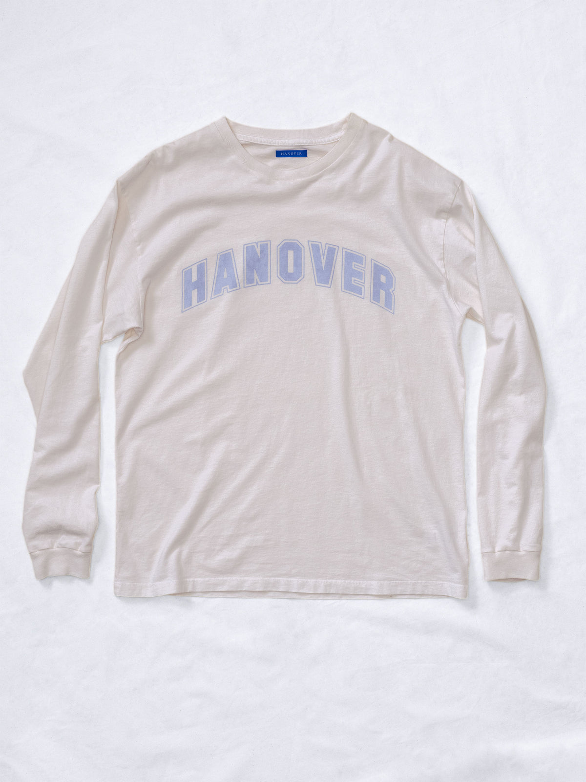 Hanover Long Sleeve Tee in faded light purple graphic on natural washed white cotton, front view.