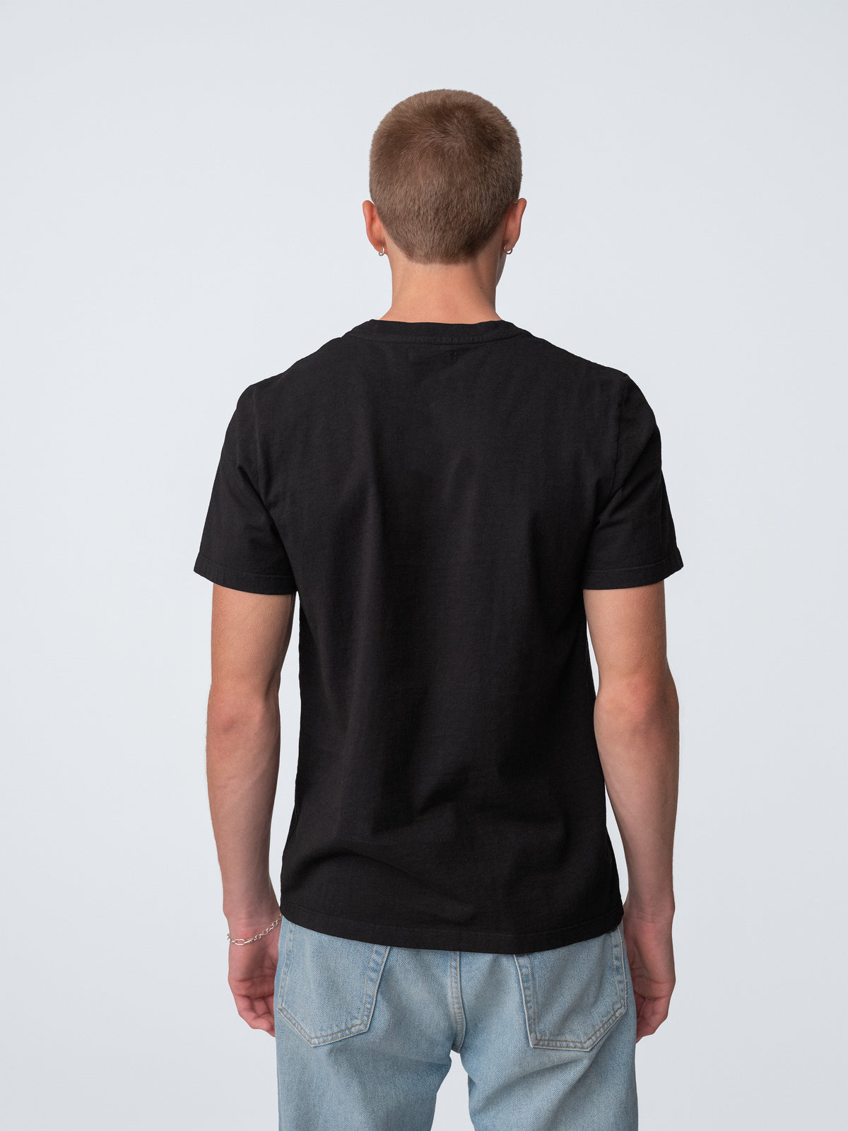 Model guy wearing Staple T-Shirt in true black back view