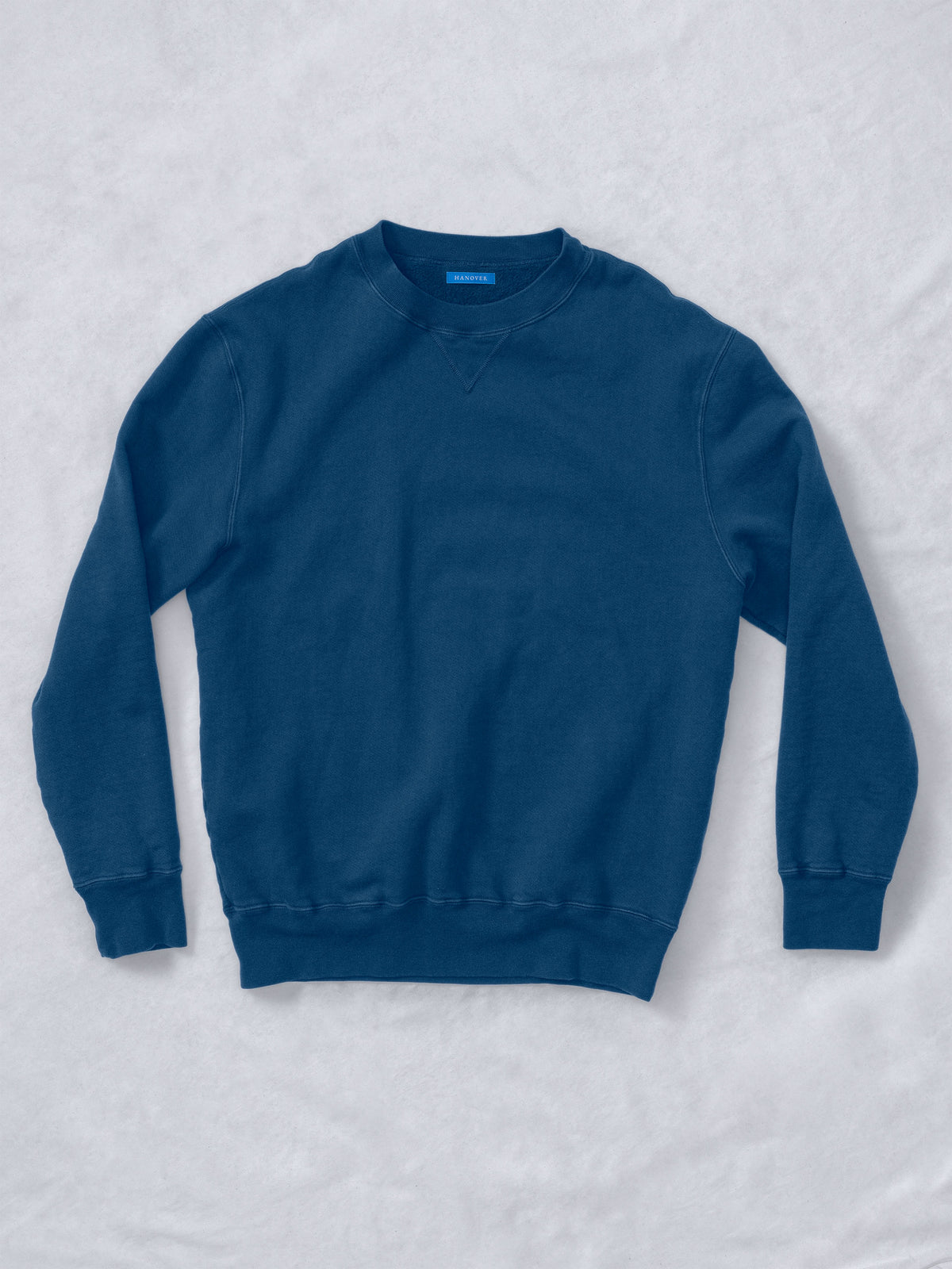 Flat lay of Guy Sunwashed Staple Crewneck in mid navy