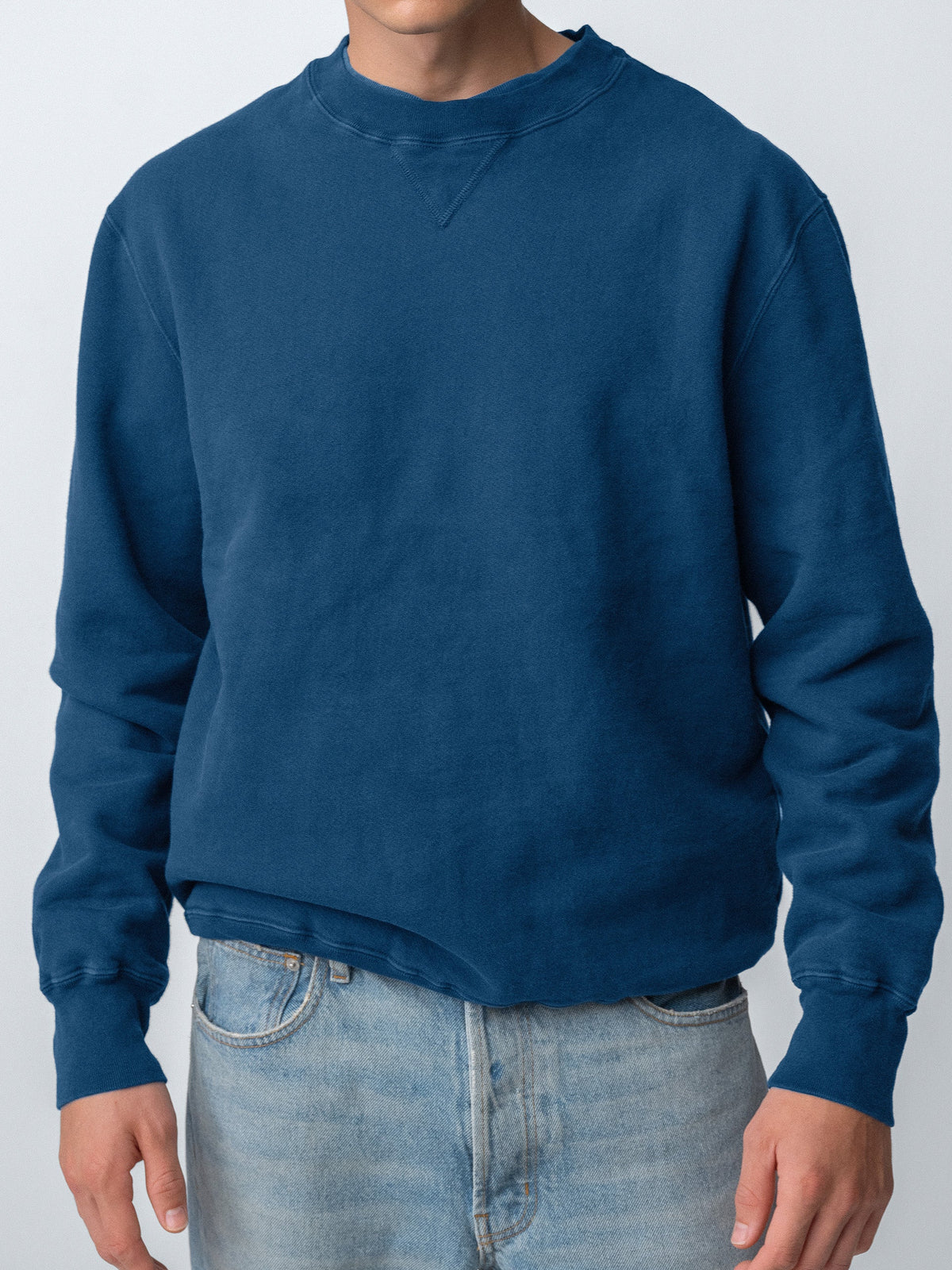 Guy wearing Sunwashed Staple Crewneck in mid navy torso view