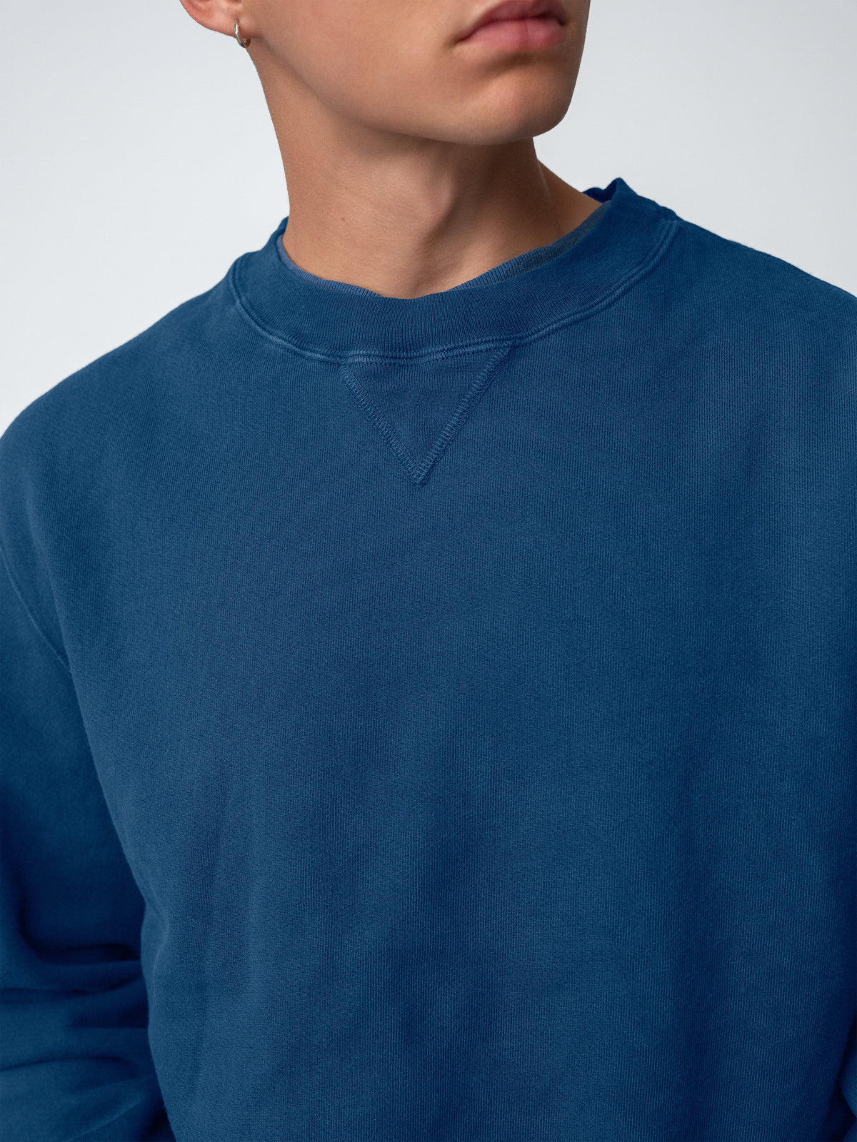 Detail of guy wearing Sunwashed Staple Crewneck mid navy