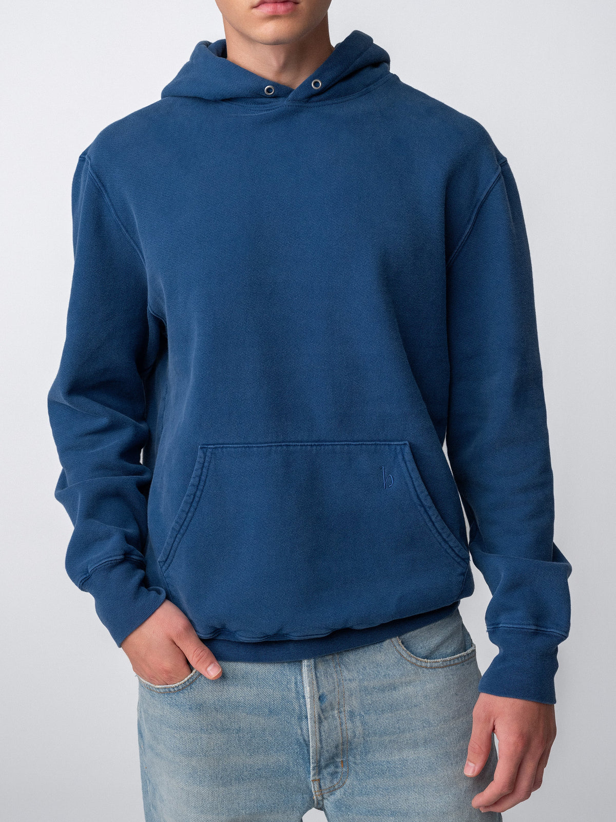 Model wearing Sunwashed Staple Hoodie in mid navy