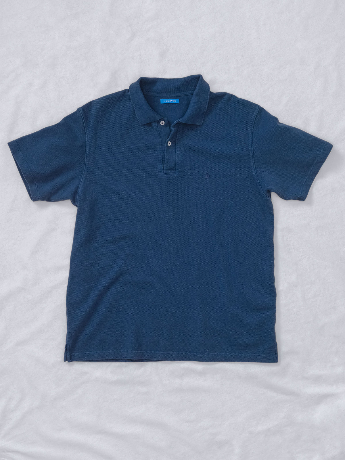 Flat lay of Sunwashed Staple Polo Shirt in mid navy color