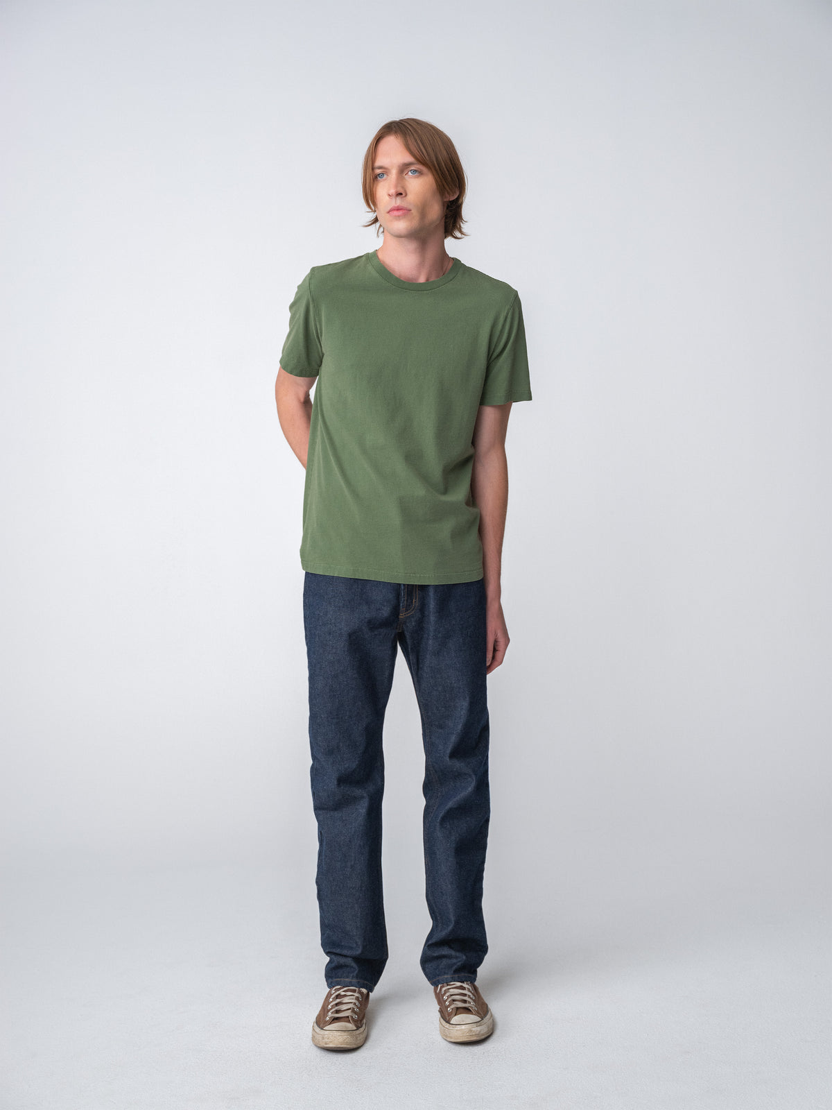 Model wearing Sunwashed Staple T-Shirt in spruce full body view