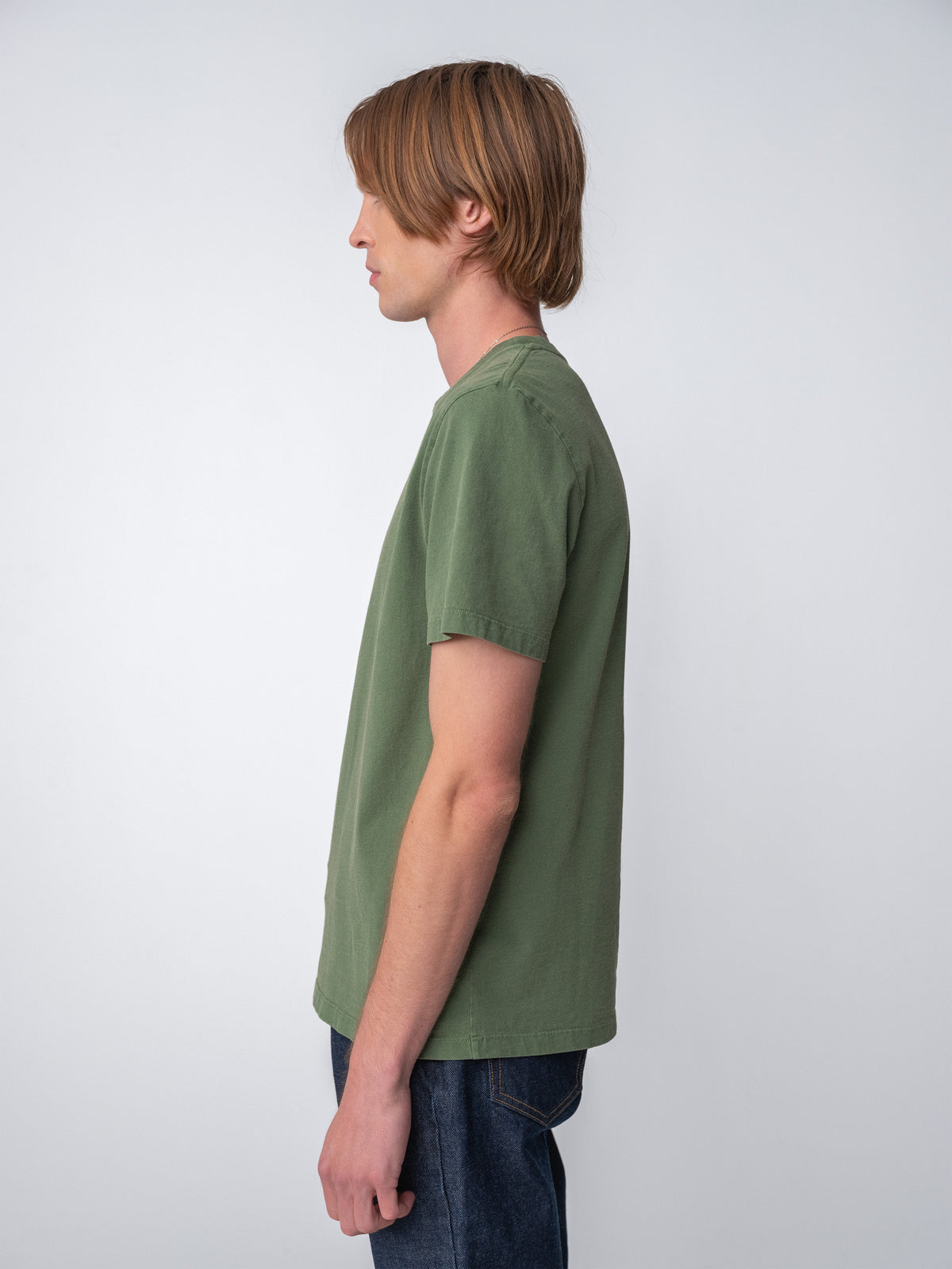 Model wearing Sunwashed Staple T-Shirt in spruce side view