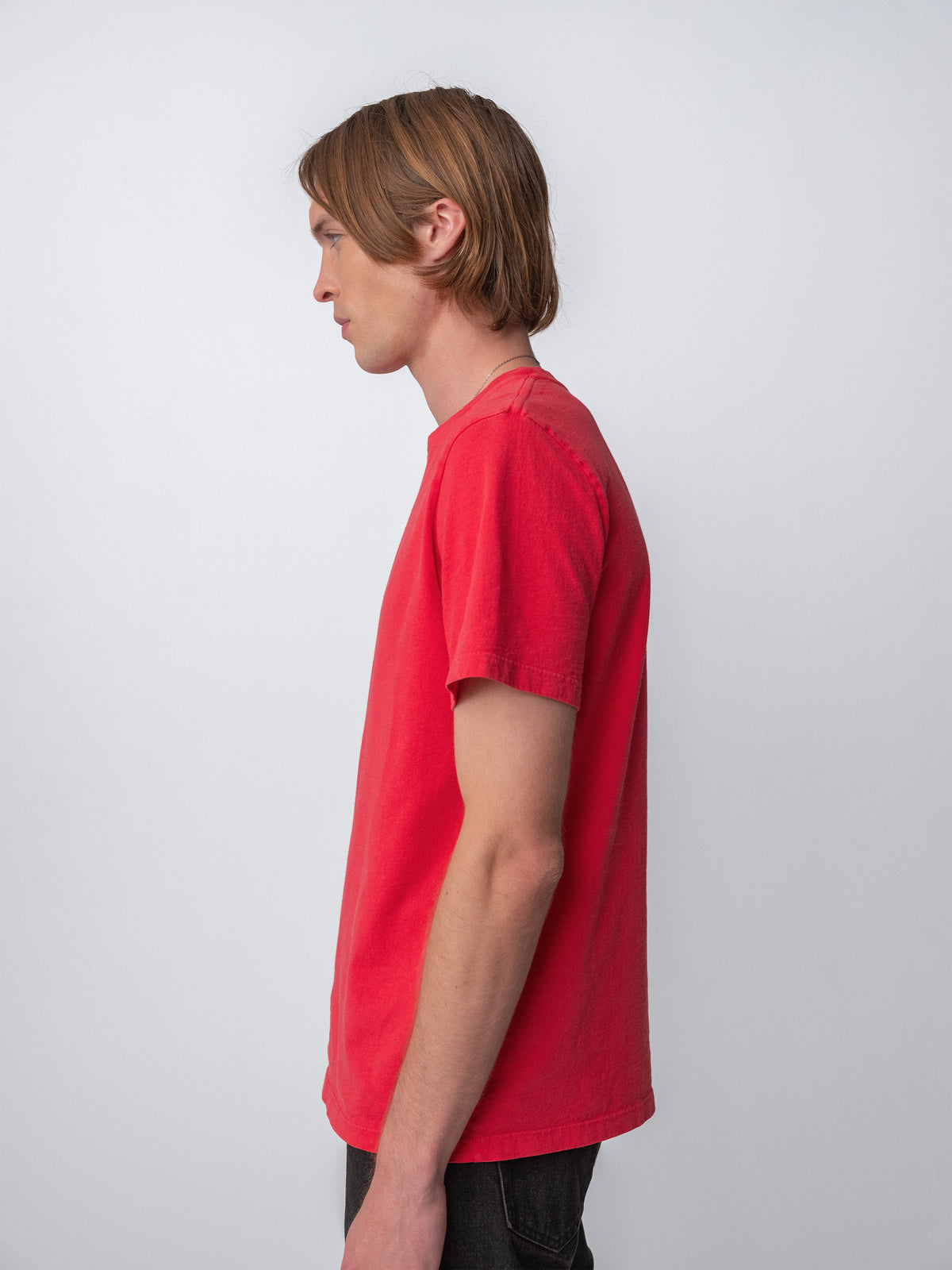 Model wearing Sunwashed Staple T-Shirt in cherry side view