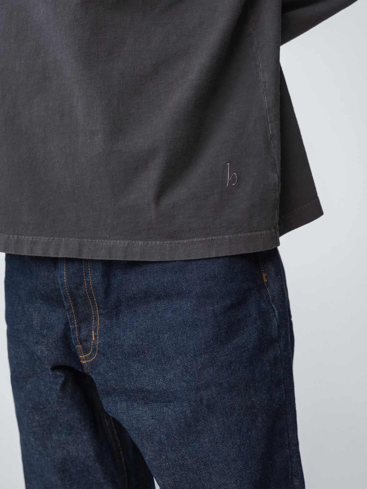 Model wearing Sunwashed Staple T-Shirt in charcoal detail close up view