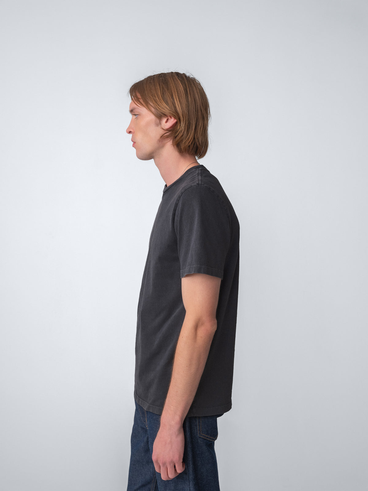 Model wearing Sunwashed Staple T-Shirt in charcoal side view
