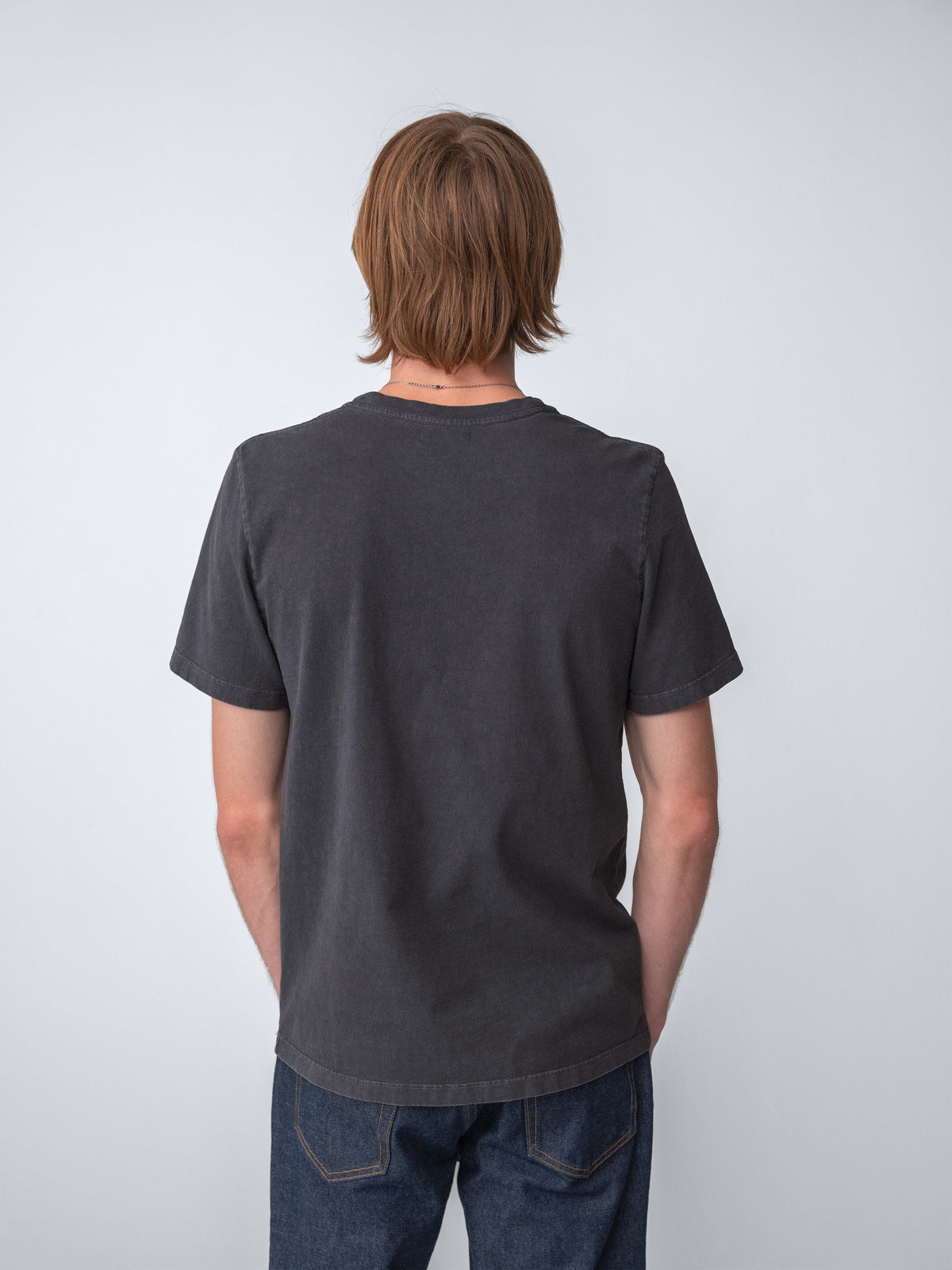 Model wearing Sunwashed Staple T-Shirt in charcoal back view