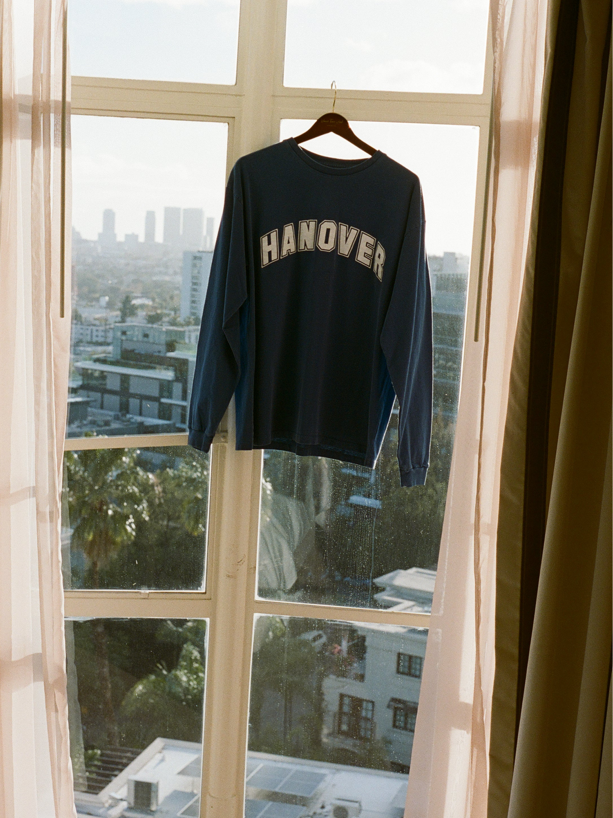 lifestyle image of a mid navy Hanover Long Sleeve Tee 